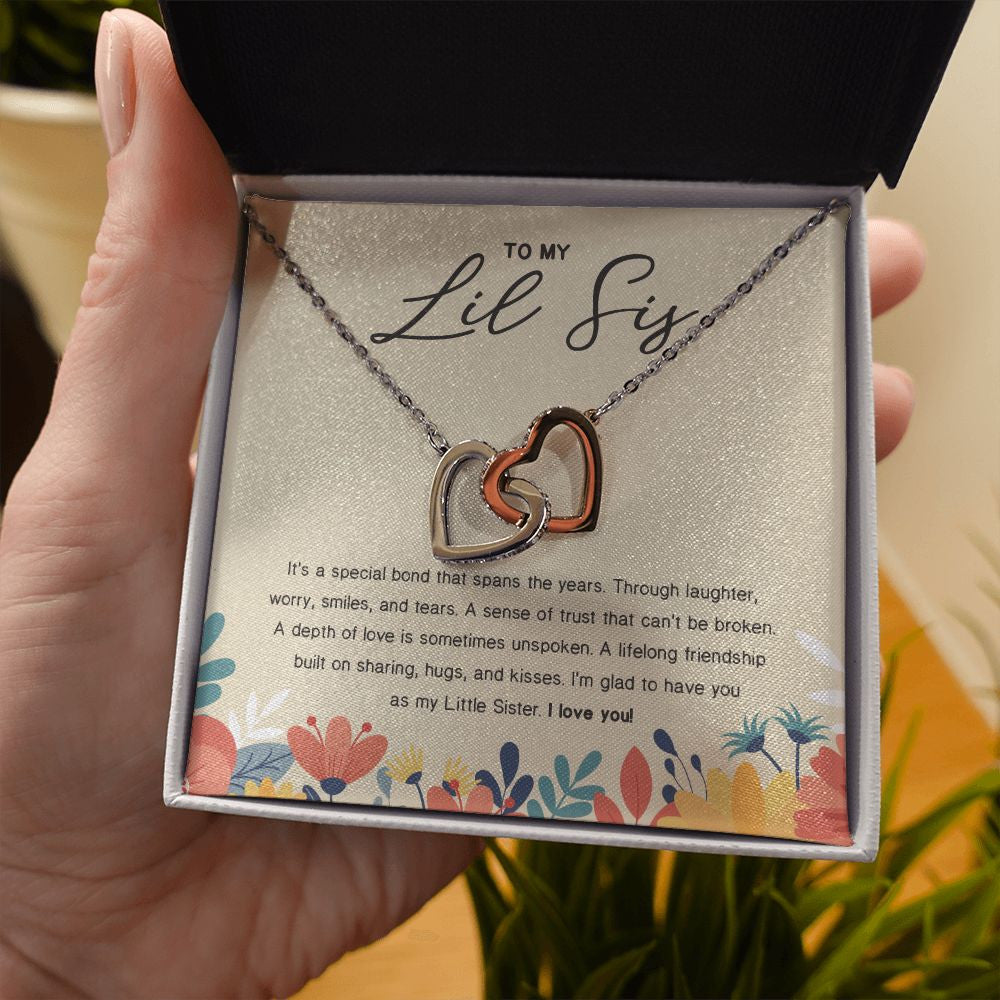 Lifelong friendship interlocking heart necklace in hand