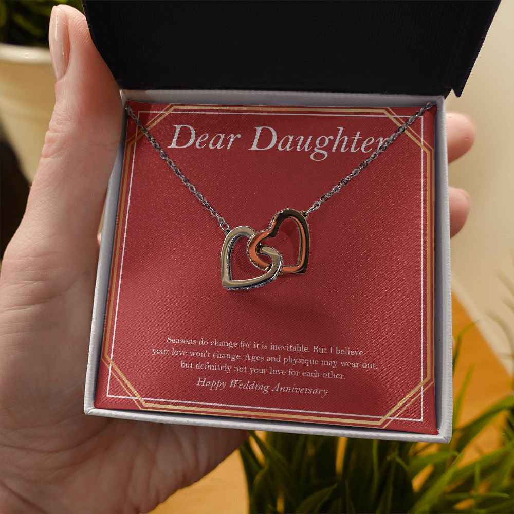 Love Won't Change interlocking heart necklace in hand