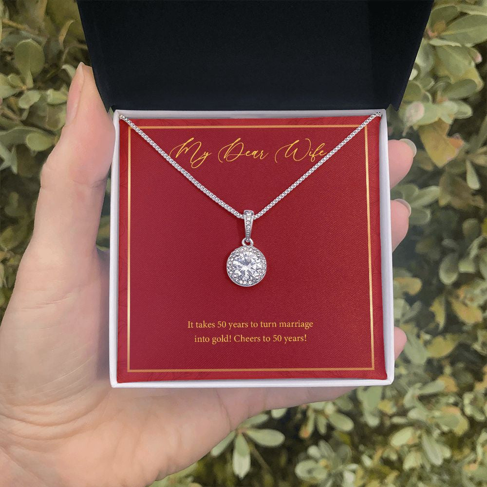 Marriage Into Gold eternal hope necklace in hand