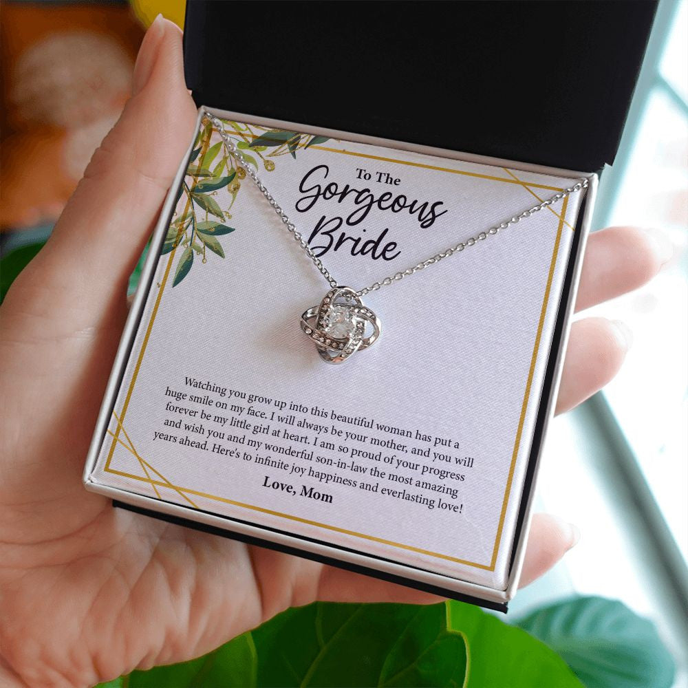 Proud Of Your Progress love knot necklace in hand