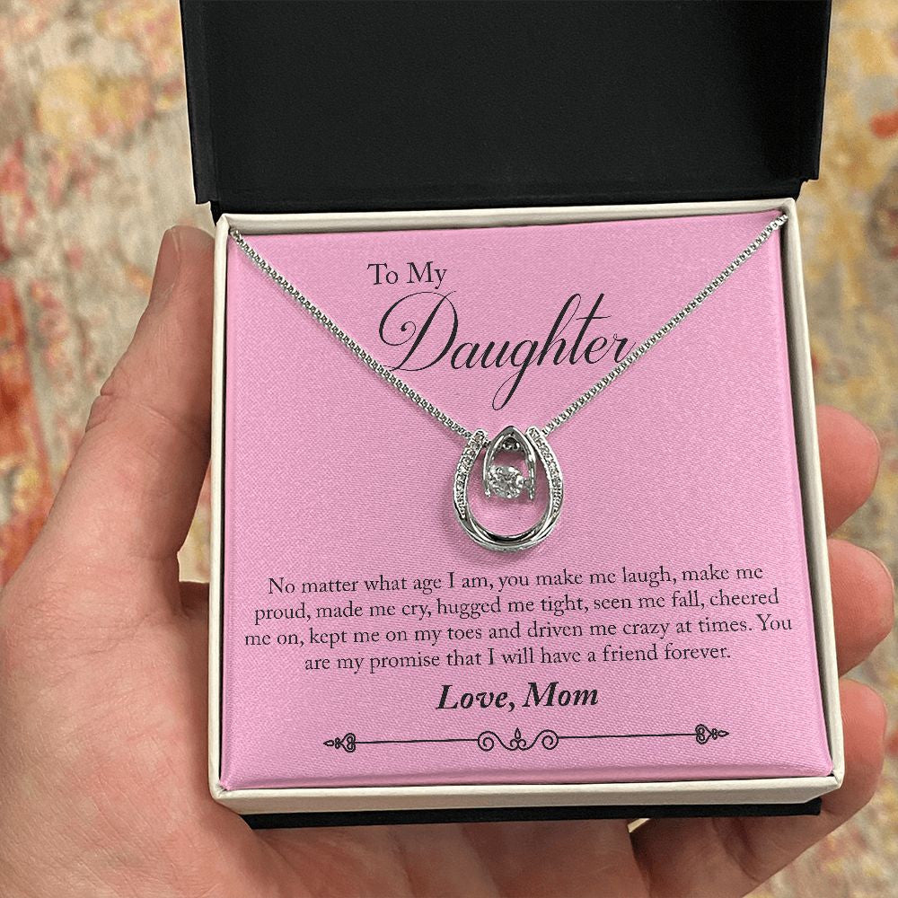 Hugged Me Tight horseshoe necklace in hand