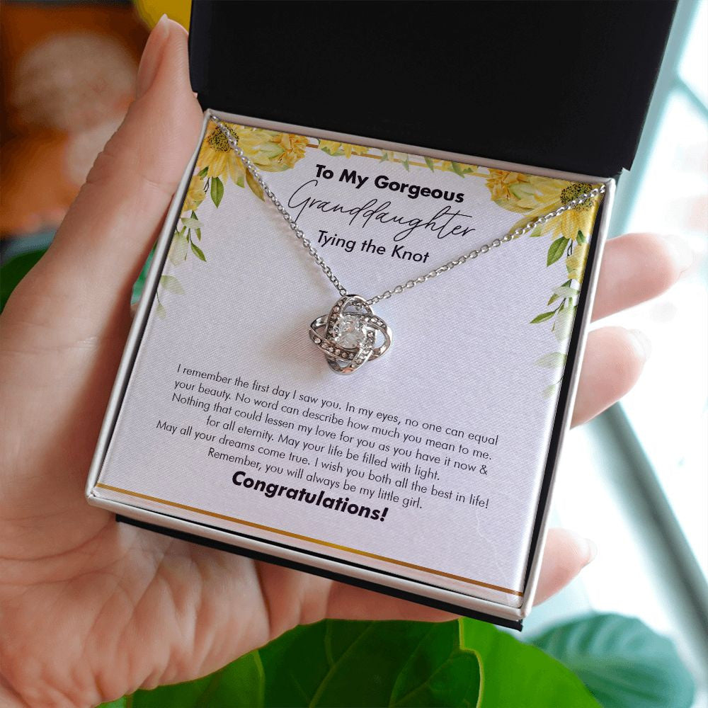 No One Can Equal love knot necklace in hand