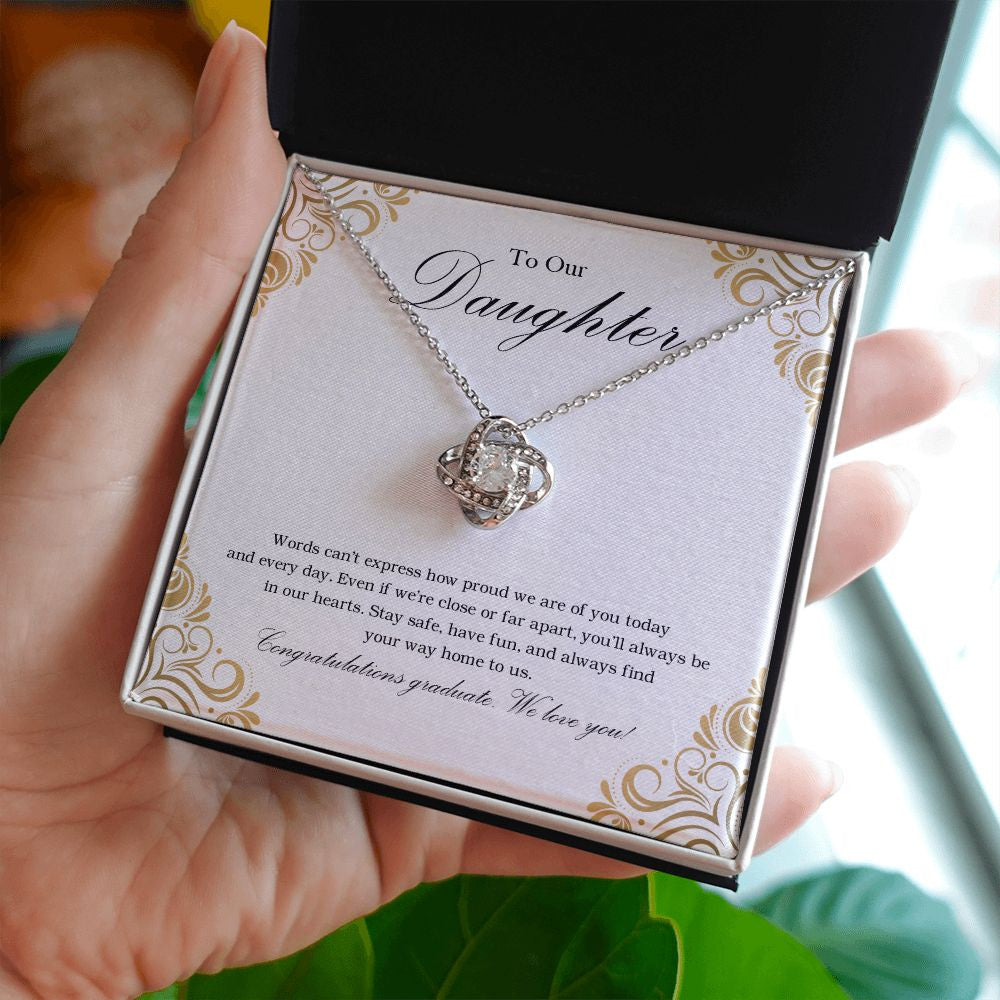 Way Home To Us love knot necklace in hand