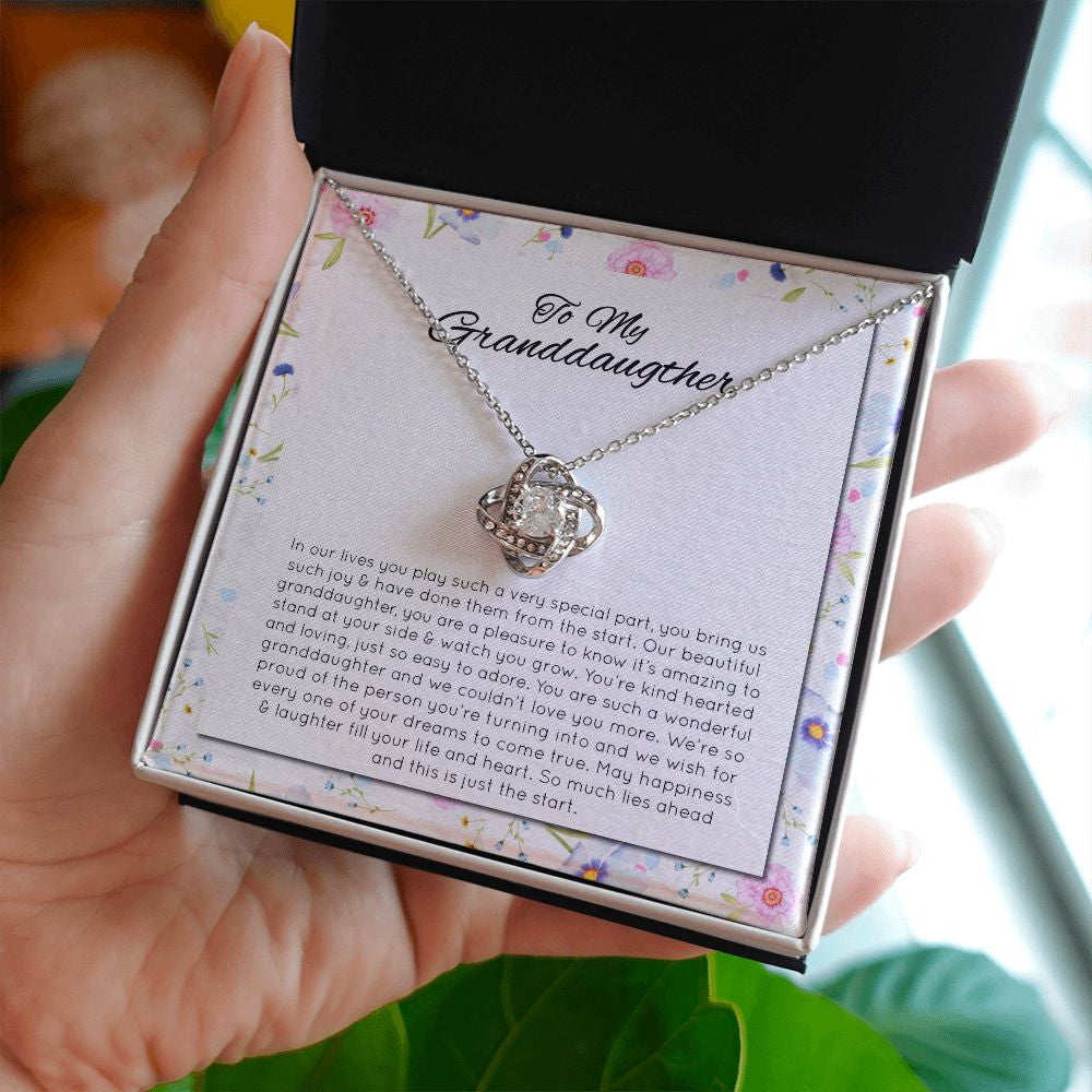 Happiness & Laughter love knot necklace in hand