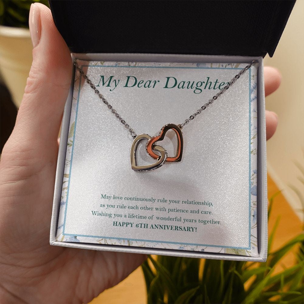 A Lifetime Of Years interlocking heart necklace in hand