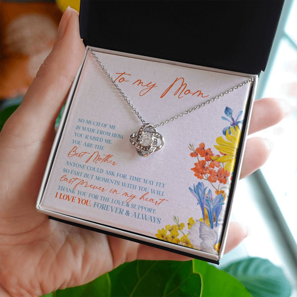 Love and Support love knot necklace in hand