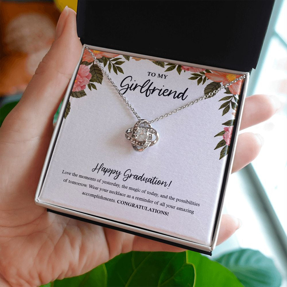 The Magic Of Today love knot necklace in hand