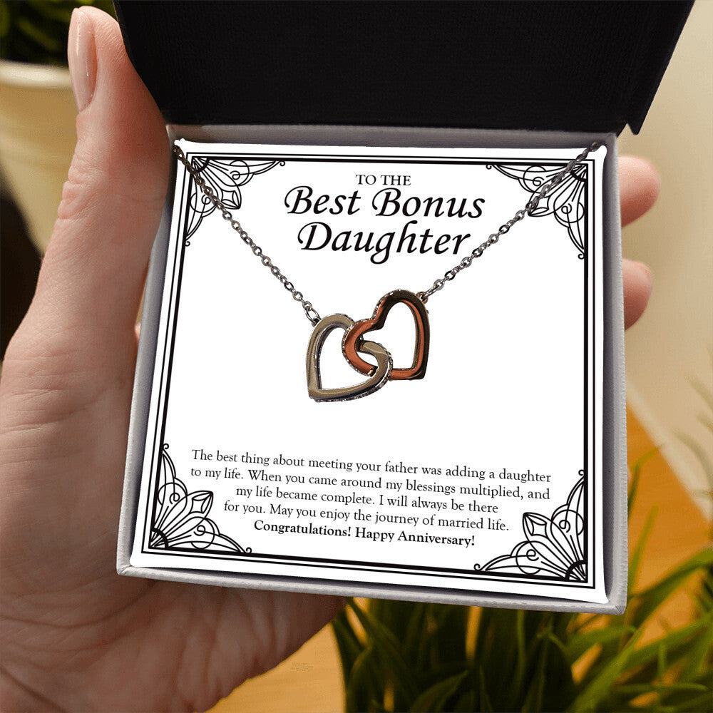 Adding You In My Life interlocking heart necklace in hand