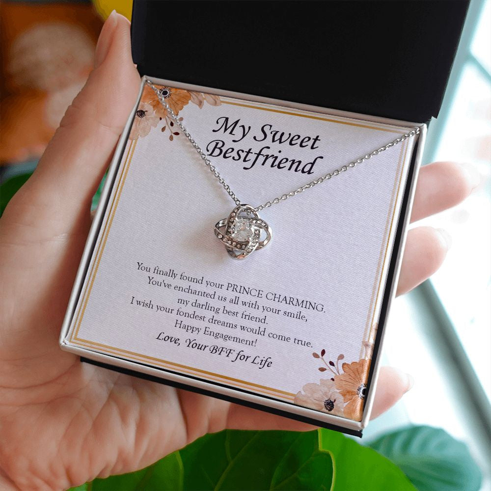 Enchanted With A Smile love knot necklace in hand