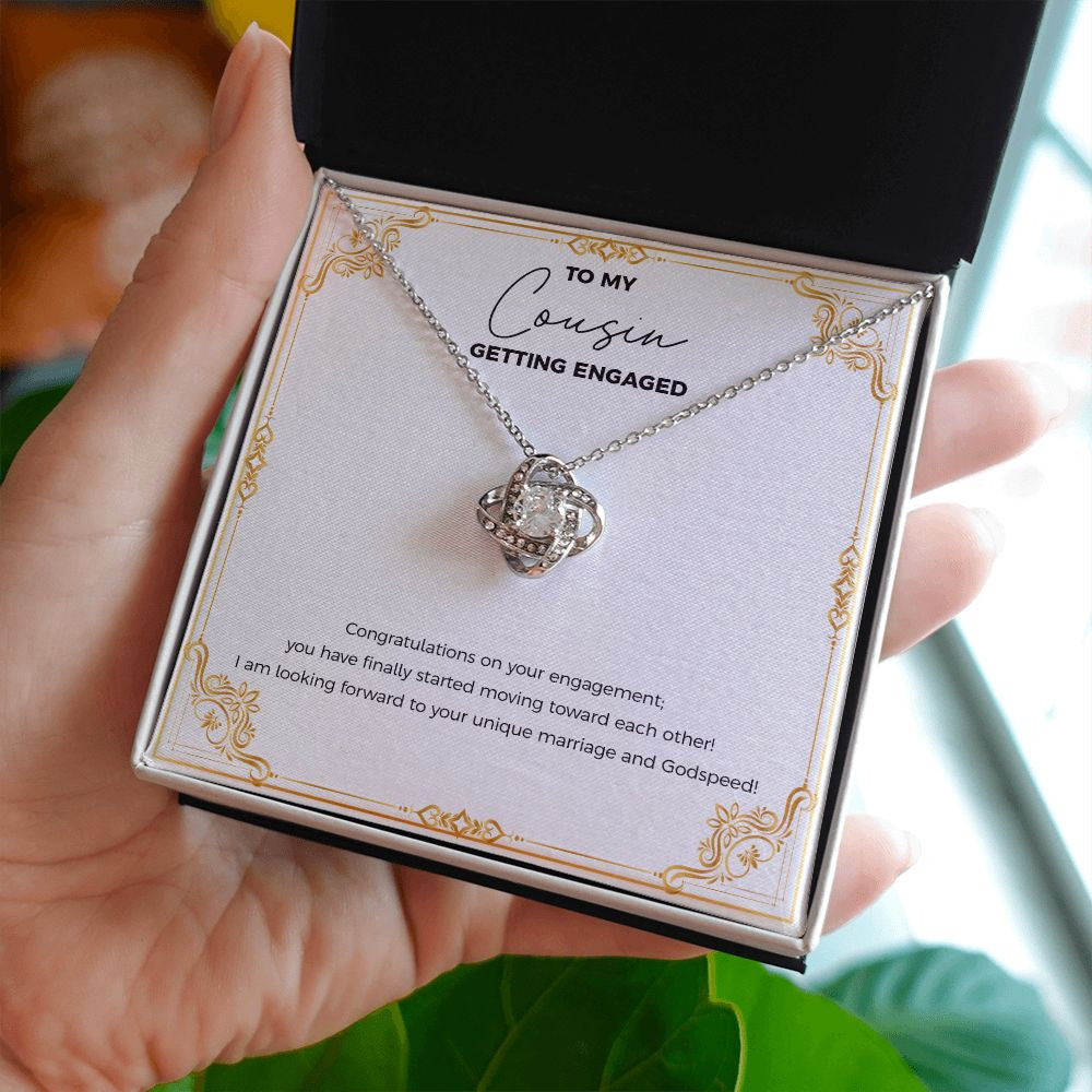 Finally Moving Each Other love knot necklace in hand