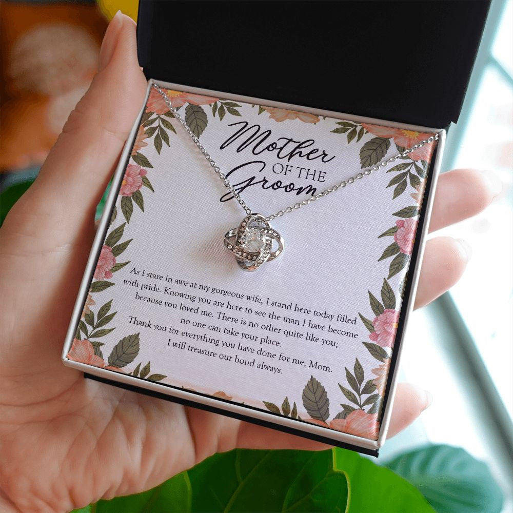 Filled With Pride love knot necklace in hand