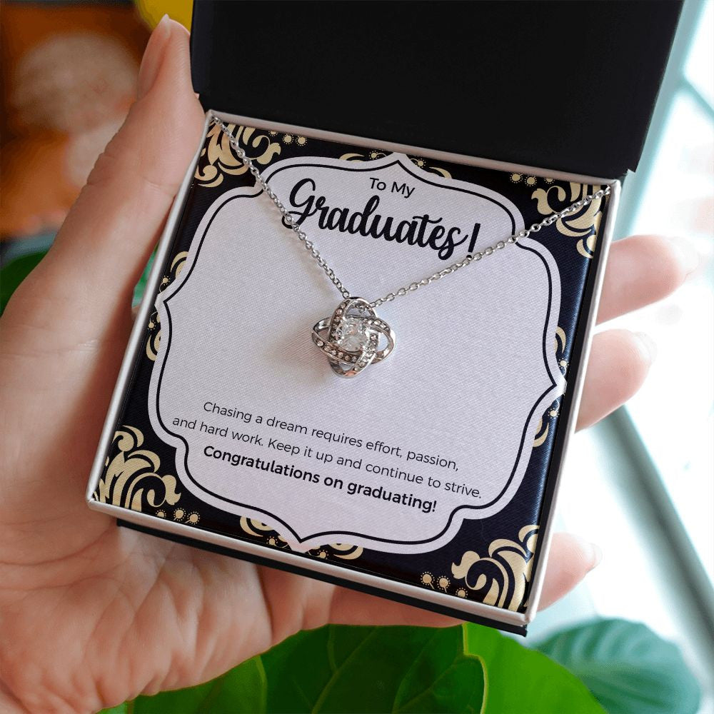 Continue To Strive love knot necklace in hand