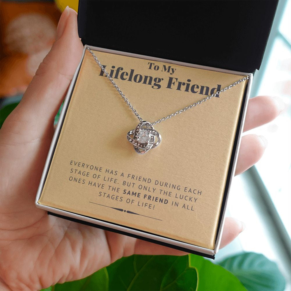 But Only The Lucky One love knot necklace in hand