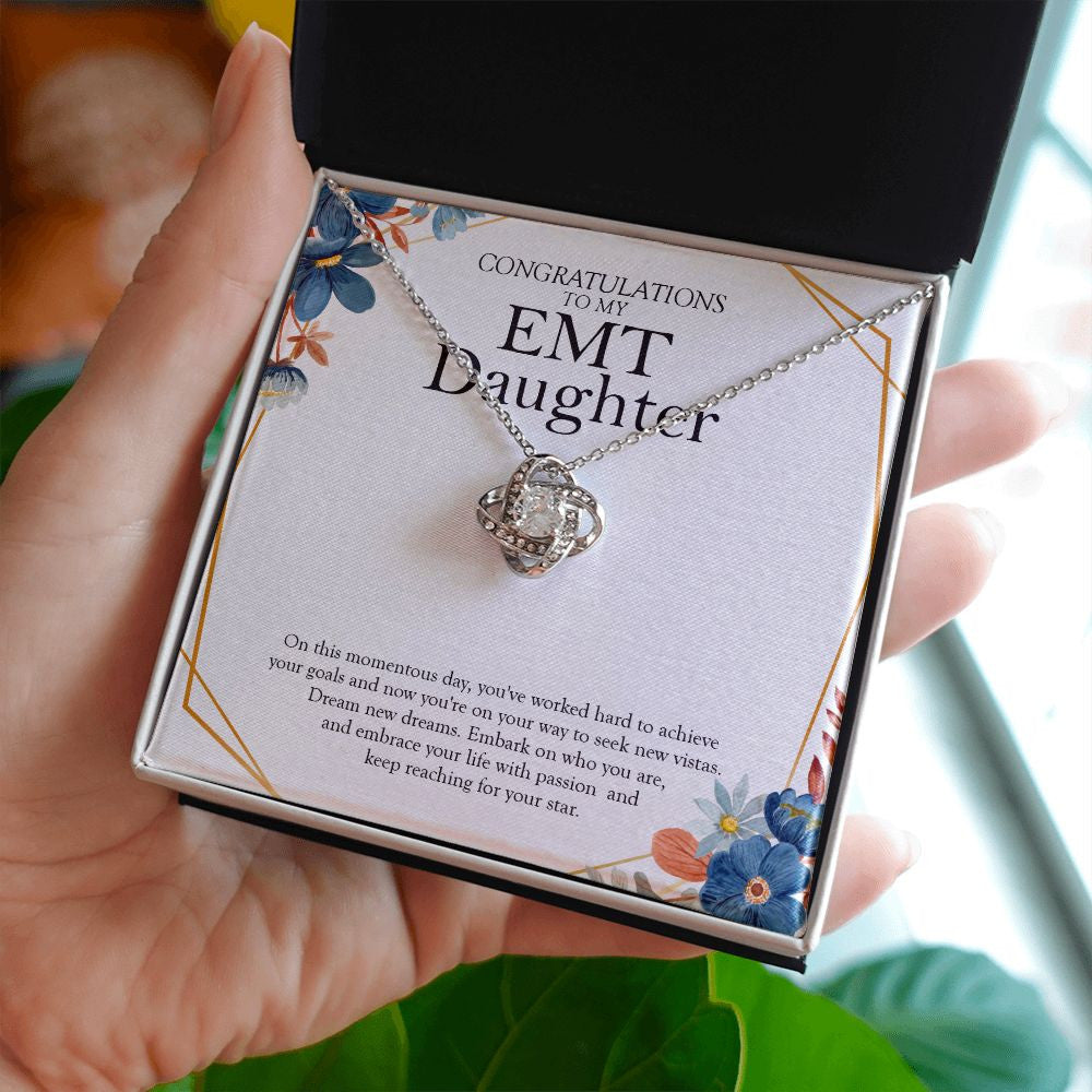 Keep Reaching For Your Star love knot necklace in hand