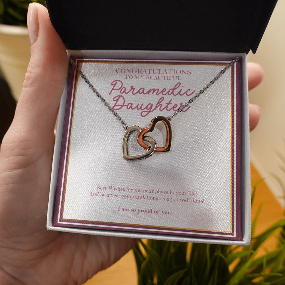 Job Well Done interlocking heart necklace in hand