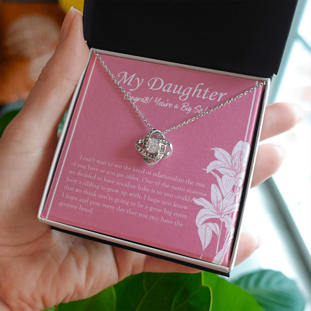 Sibling To Grow Up With love knot necklace in hand