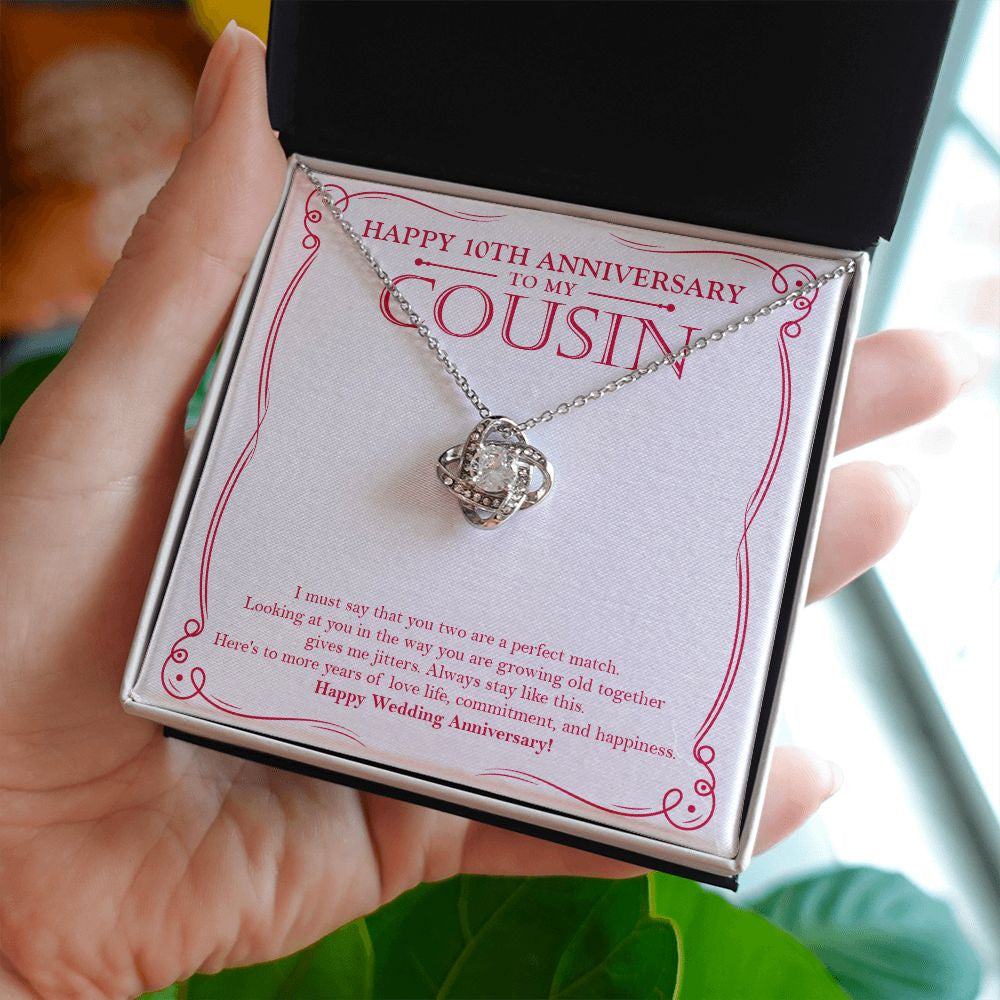 A Perfect Match love knot necklace in hand