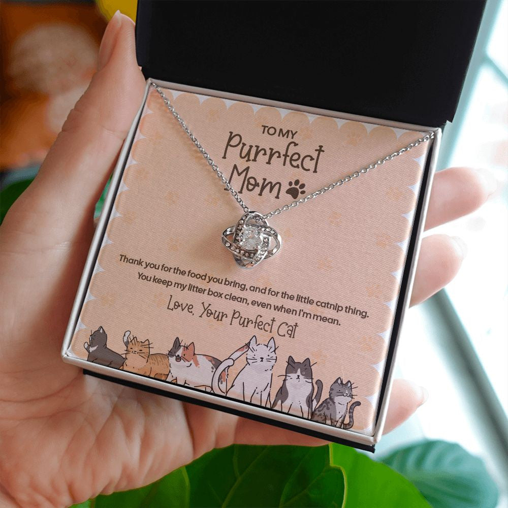 Even When I'm Mean love knot necklace in hand