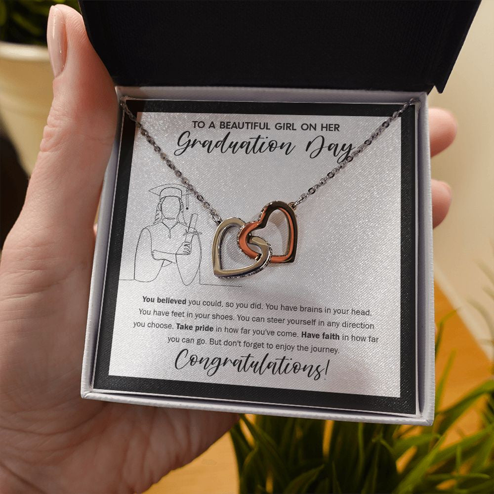 Direction you Choose interlocking heart necklace in hand