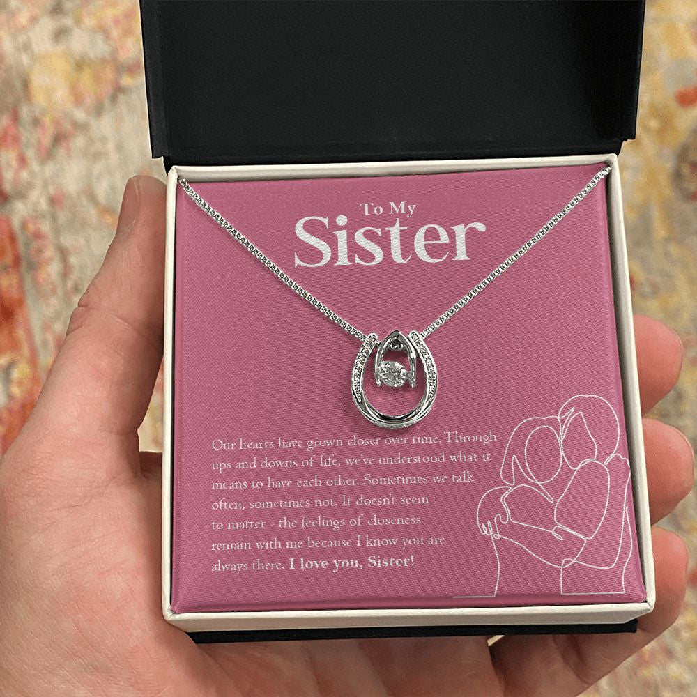 Grown Closer horseshoe necklace in hand