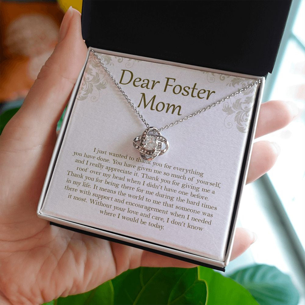 Everything You've Done love knot necklace in hand