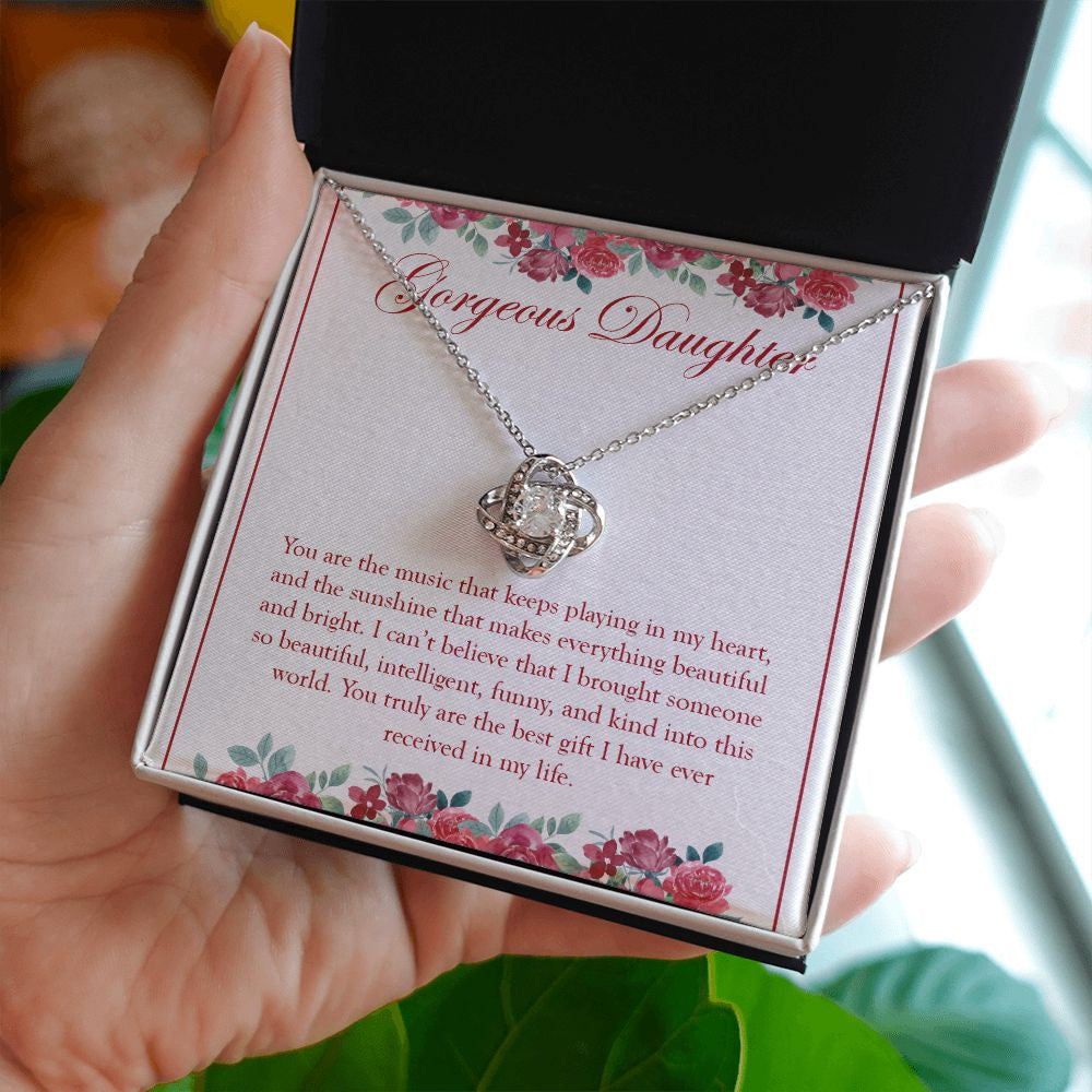 Our Beautiful Sunshine love knot necklace in hand