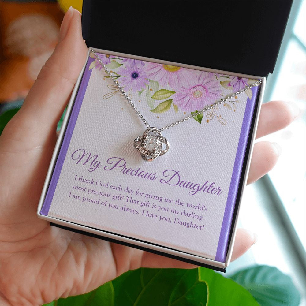 World's Most Precious Present love knot necklace in hand
