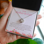 Deserves All The Good Things love knot necklace in hand