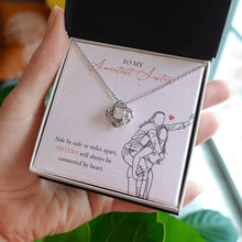 Load image into Gallery viewer, Connected by heart love knot necklace in hand
