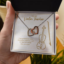 Load image into Gallery viewer, Love Of Music You Share interlocking heart necklace in hand
