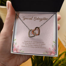 Load image into Gallery viewer, Lending A Helping Hand interlocking heart necklace in hand
