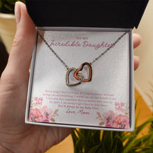 Load image into Gallery viewer, Near Or Far Apart interlocking heart necklace in hand
