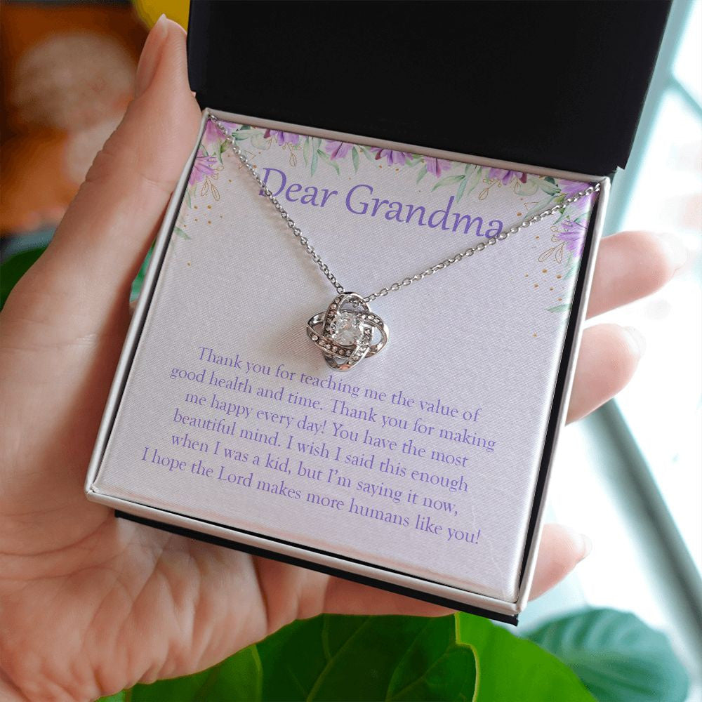 The Most Beautiful Mind love knot necklace in hand