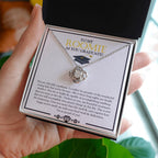 I Believe In You love knot necklace in hand