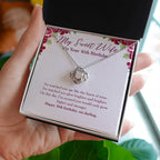 Like The Finest Of Wine love knot necklace in hand