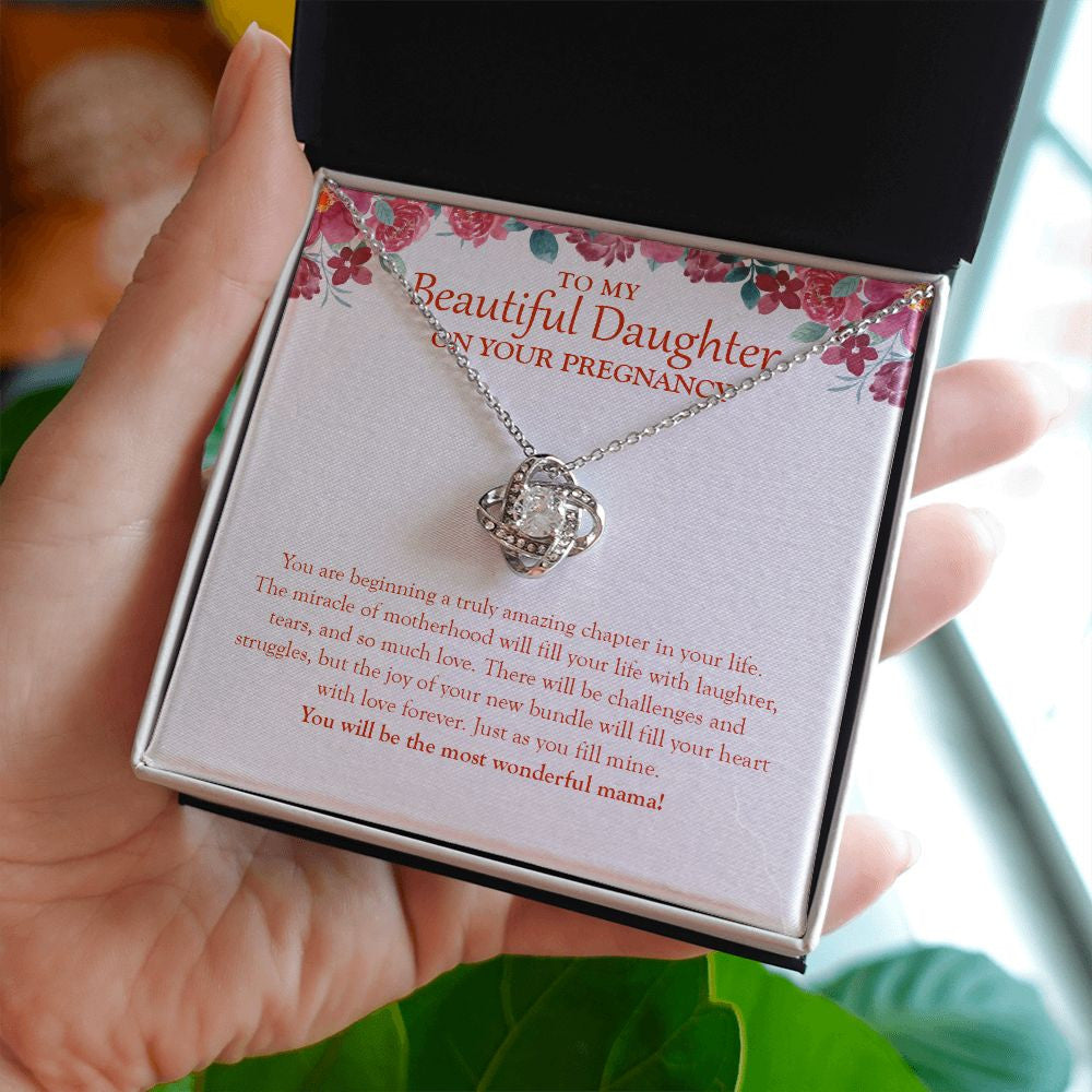 The Miracle Of Motherhood love knot necklace in hand
