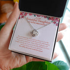 The Miracle Of Motherhood love knot necklace in hand