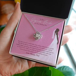 All Our Wishes Came True love knot necklace in hand