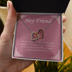 Stronger Regardless The Distance interlocking heart necklace in hand