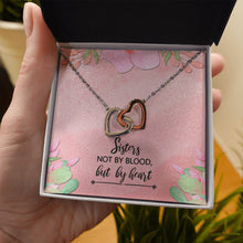 Load image into Gallery viewer, Sisters Not By Blood interlocking heart necklace in hand
