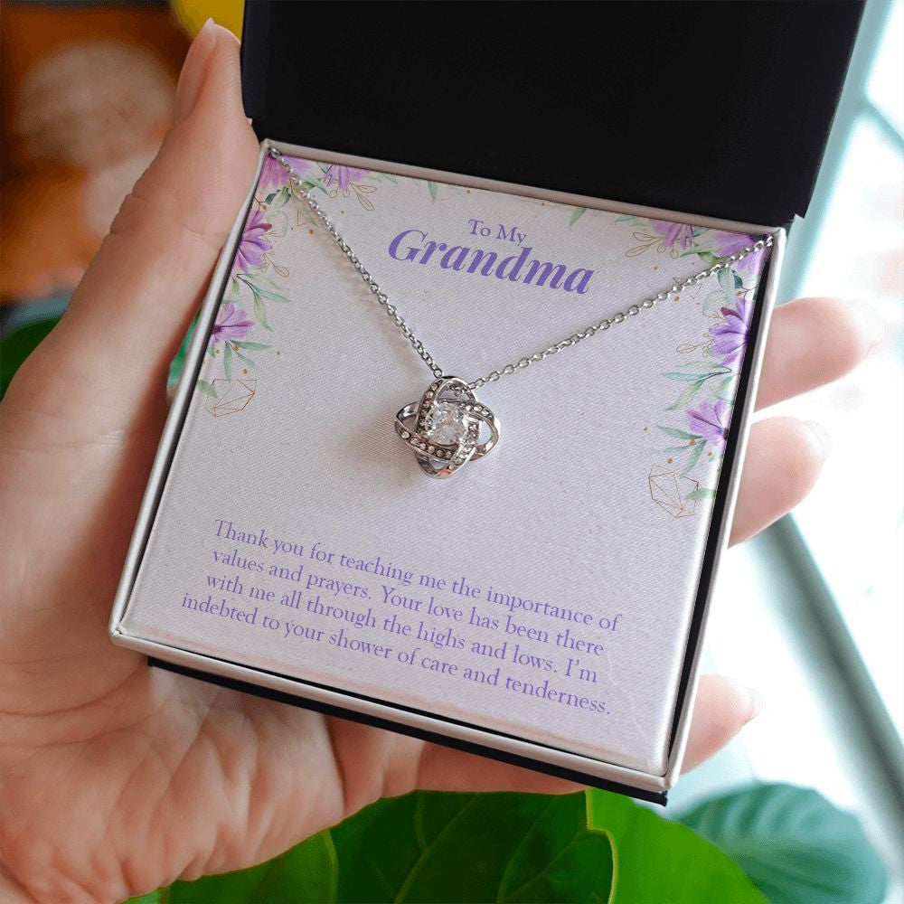 Values and Prayers love knot necklace in hand